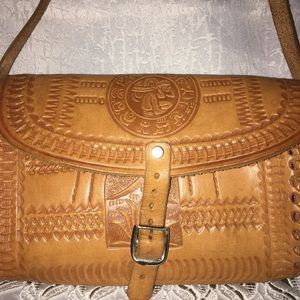 Vintage hand tooled small crossover bag.